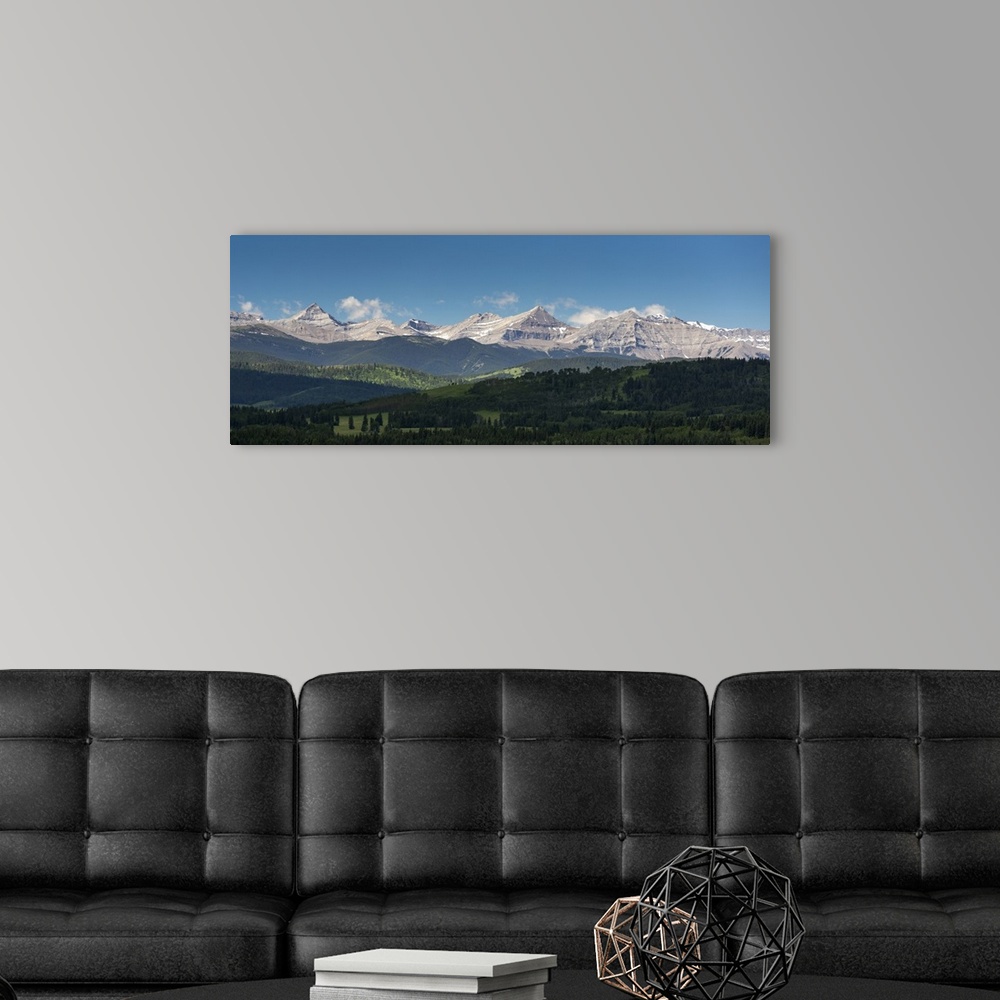 A modern room featuring Panorama of foothills and the Canadian Rockies mountain range with blue sky and clouds, West of H...