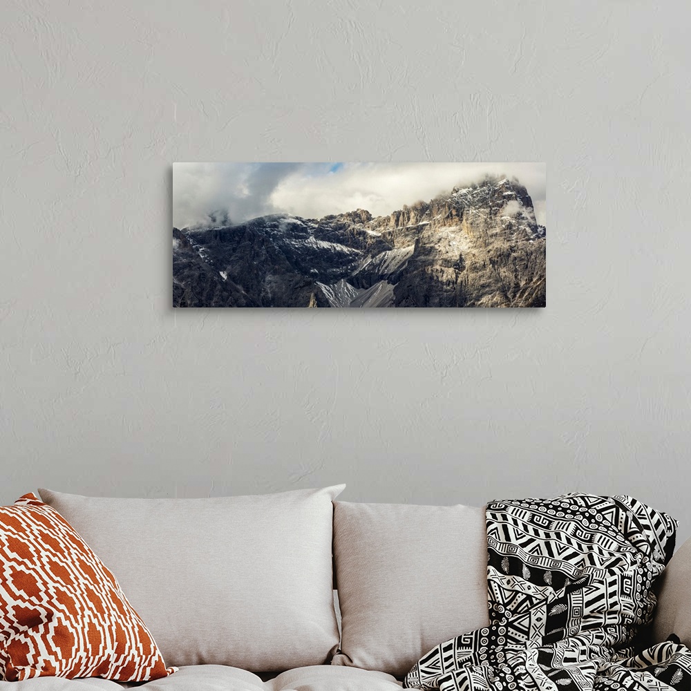 A bohemian room featuring Panorama of mountain range with cloud cover, Sesto, Bolzano, Italy.