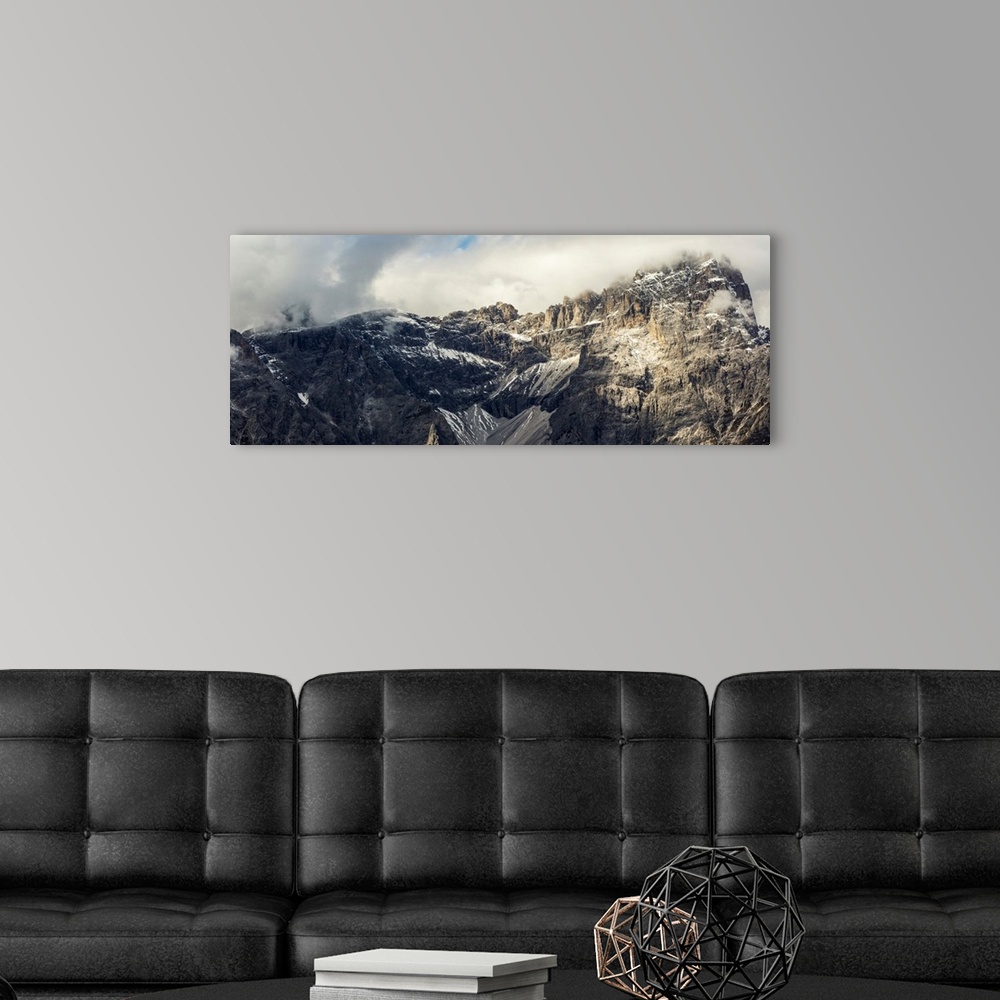 A modern room featuring Panorama of mountain range with cloud cover, Sesto, Bolzano, Italy.