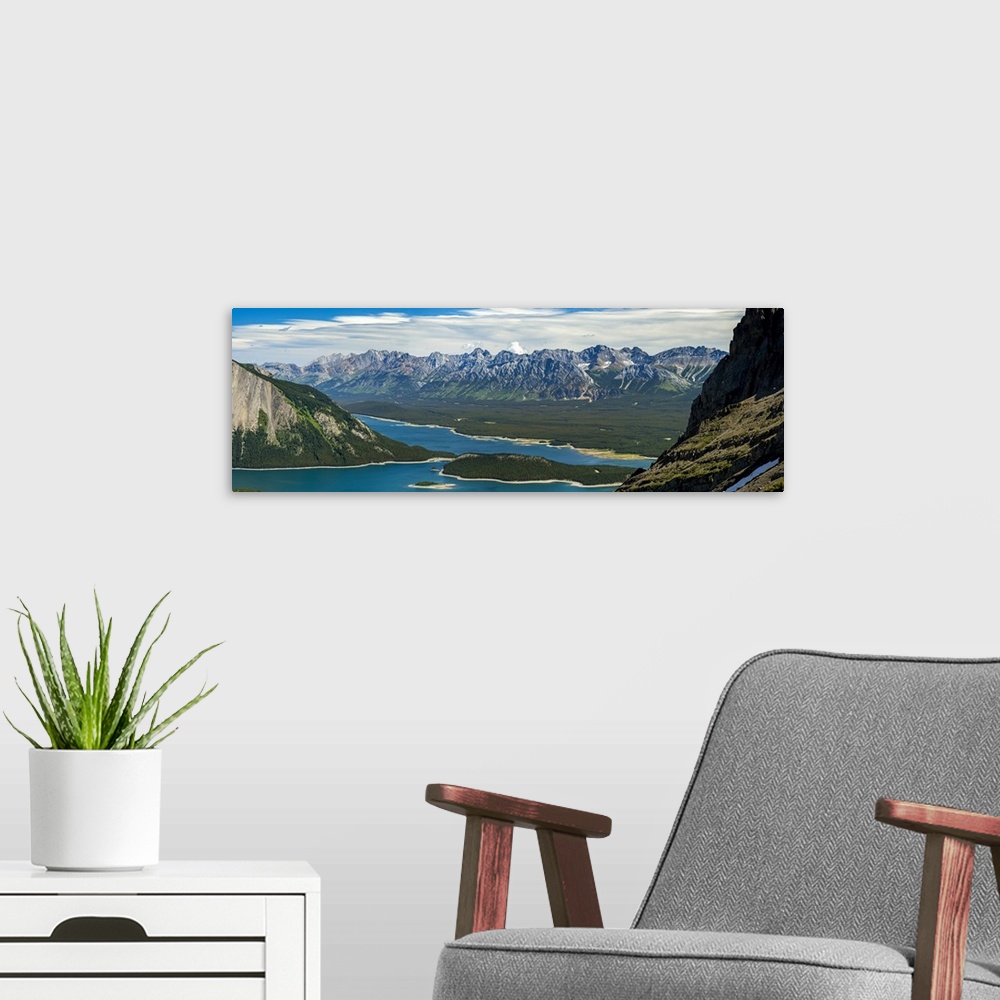 A modern room featuring Panorama on top of mountain ridge looking down on colourful alpine lake and mountain range in the...