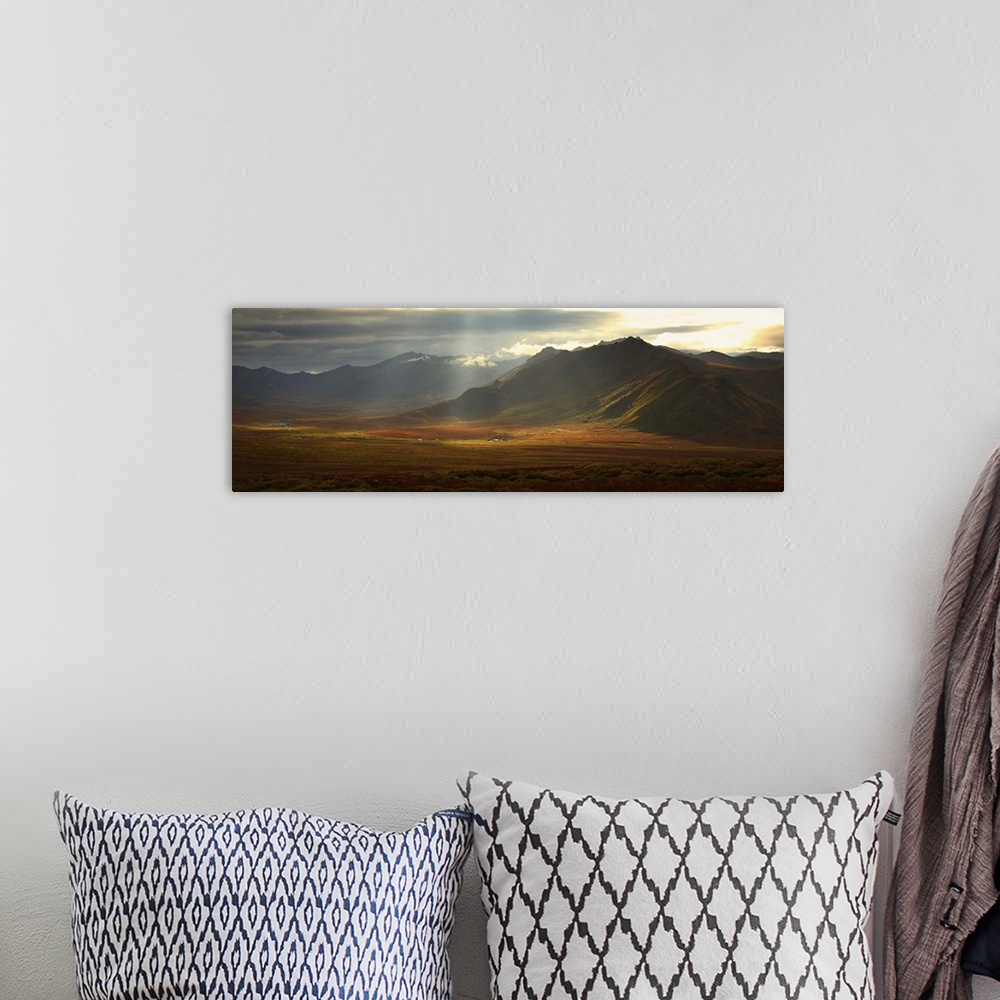 A bohemian room featuring Panoramic Image Of The Cloudy Range With Shafts Of Sunlight, Yukon, Canada