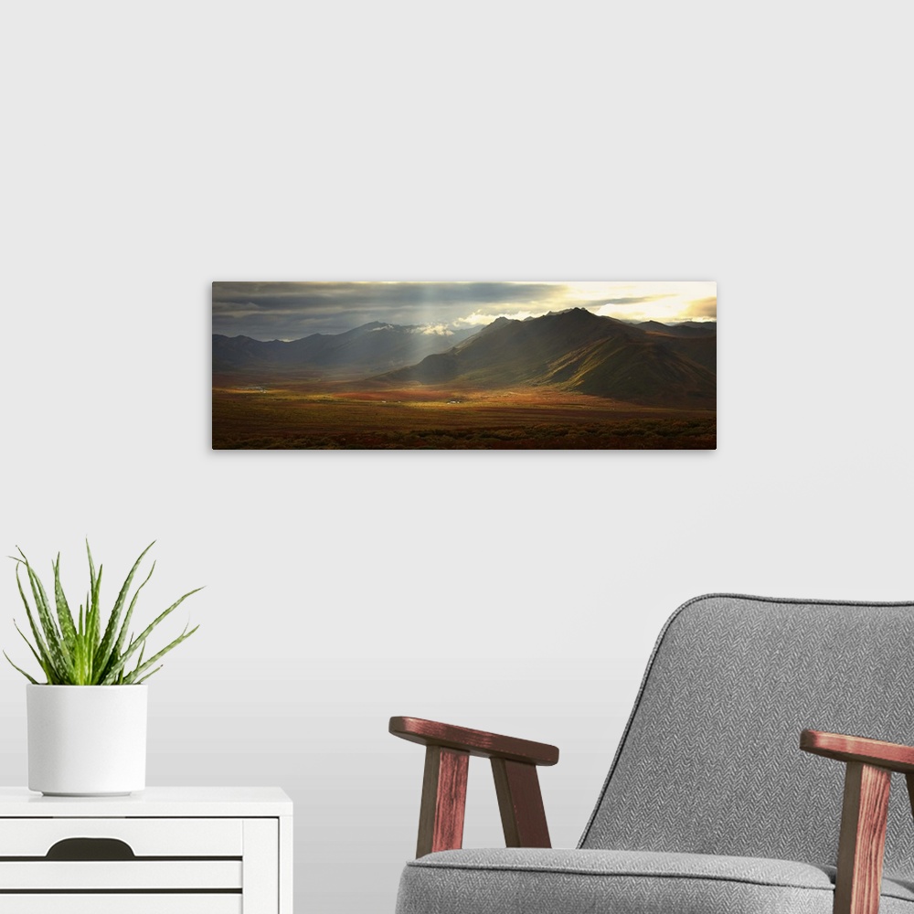 A modern room featuring Panoramic Image Of The Cloudy Range With Shafts Of Sunlight, Yukon, Canada