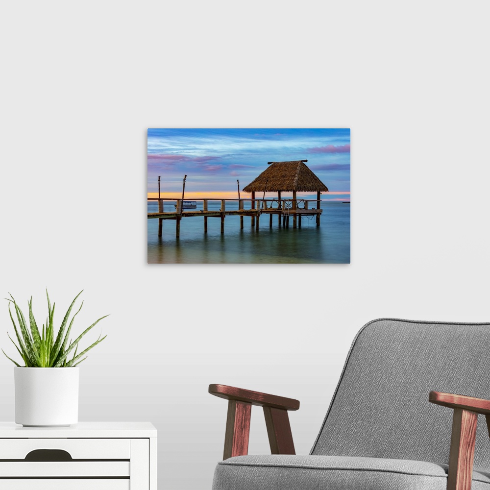 A modern room featuring Pier off Malolo Island in the South Pacific at sunrise; Malolo Island, Fiji