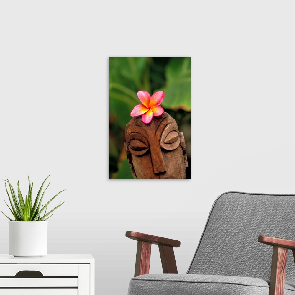 A modern room featuring Pink Plumeria Flower Atop Wooden Polynesian Statue Carving, Outdoors