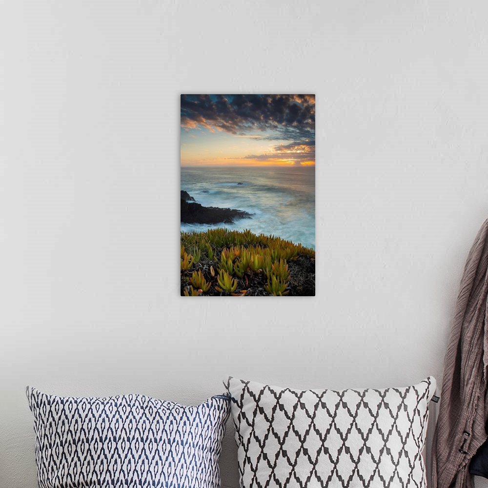 A bohemian room featuring Praia do Carvalhal with a dramatic sunrise over the horizon, Alentejo, Portugal