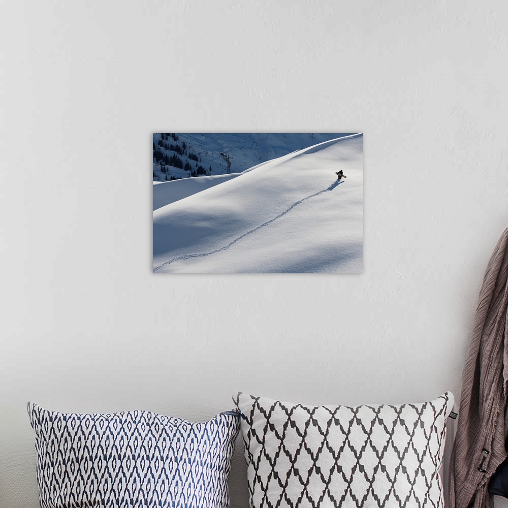 A bohemian room featuring Professional snowboarder, Gigi Ruf, carrying his board up a mountain