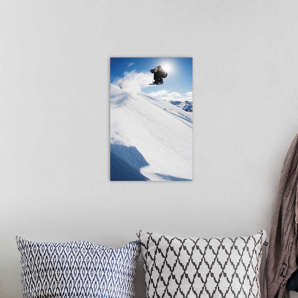 A bohemian room featuring Professional snowboarder making a jump in fresh snow near Ushuaia, Patagonia, Argentina