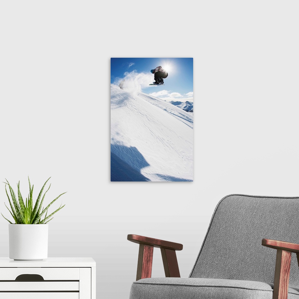 A modern room featuring Professional snowboarder making a jump in fresh snow near Ushuaia, Patagonia, Argentina