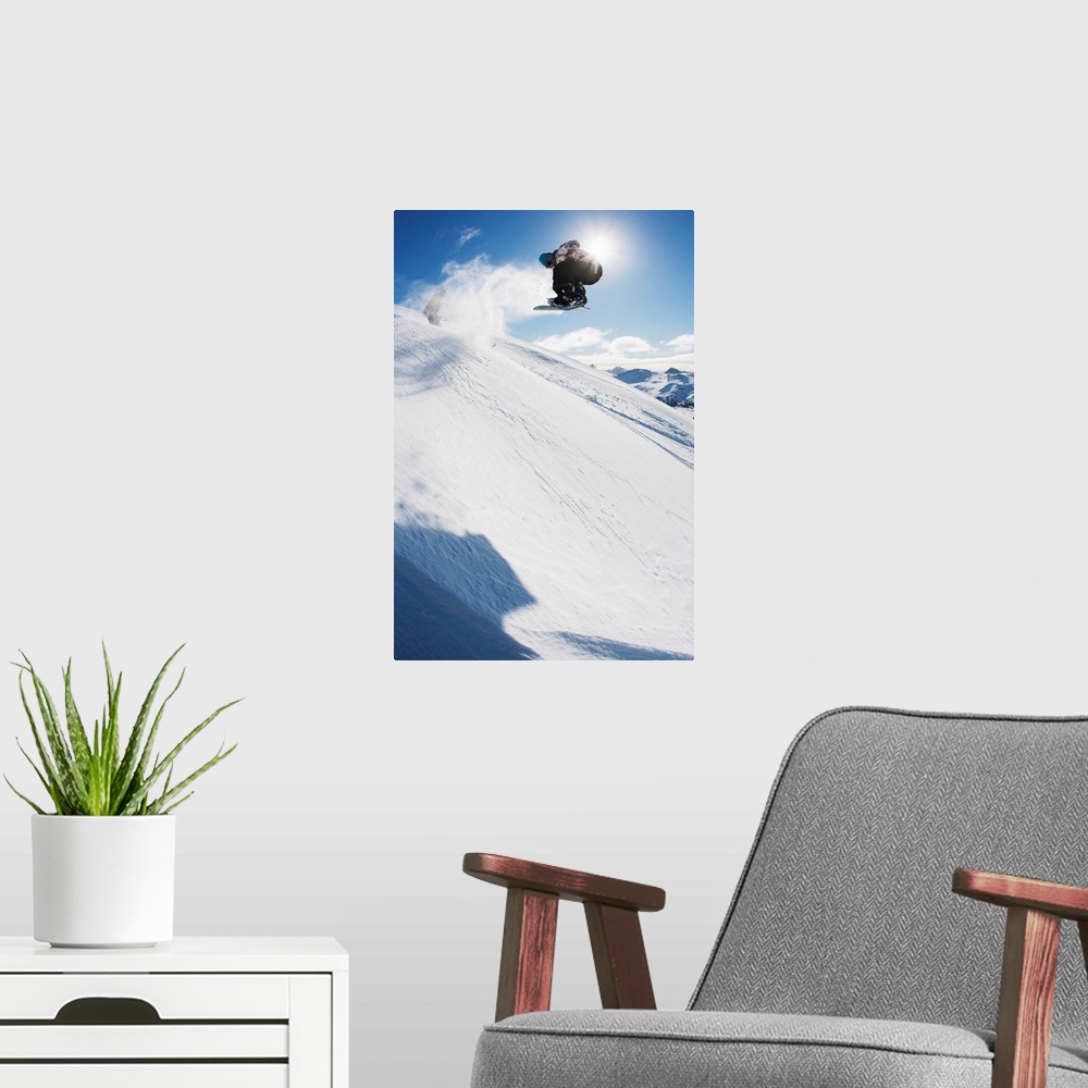 A modern room featuring Professional snowboarder making a jump in fresh snow near Ushuaia, Patagonia, Argentina