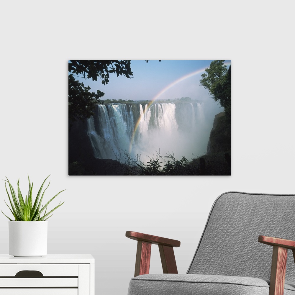 A modern room featuring Rainbow In Front Of Victoria Falls; Zimbabwe