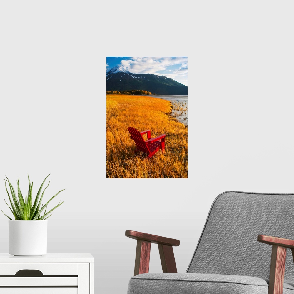 A modern room featuring Vertical, large photograph of a single adirondack chair sitting at the edge of a grassy coastline...