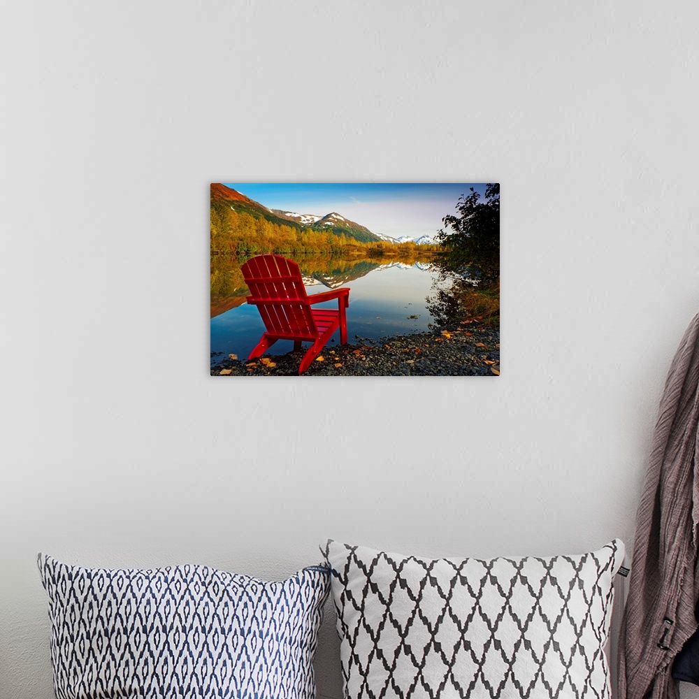 A bohemian room featuring Landscape photograph on a big canvas of a red Adirondack chair sitting at the edge of a lake that...