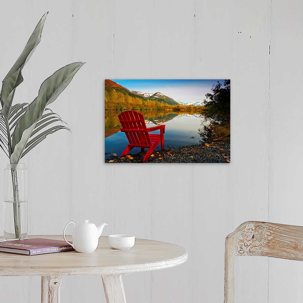 A farmhouse room featuring Landscape photograph on a big canvas of a red Adirondack chair sitting at the edge of a lake that...