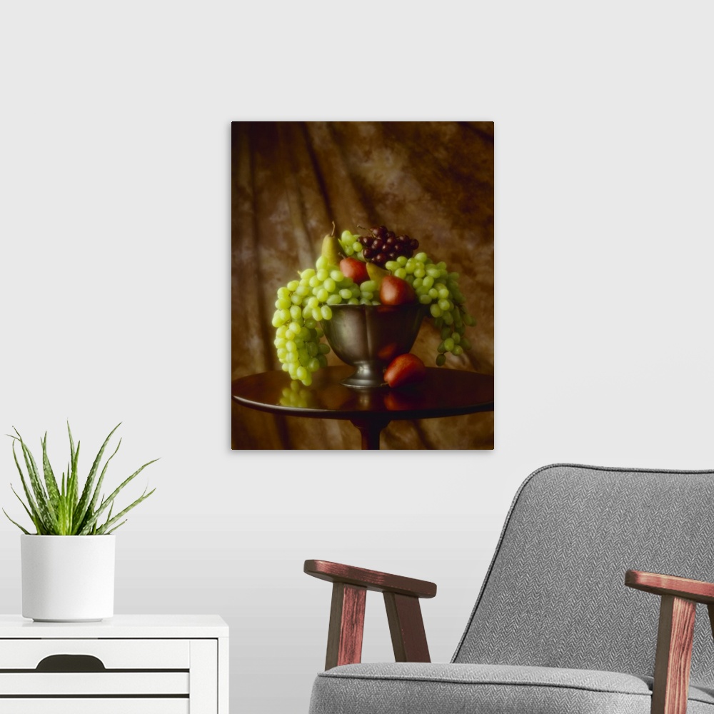 A modern room featuring Red and green grapes and Red Bartlett and Bosc pears in a bowl.