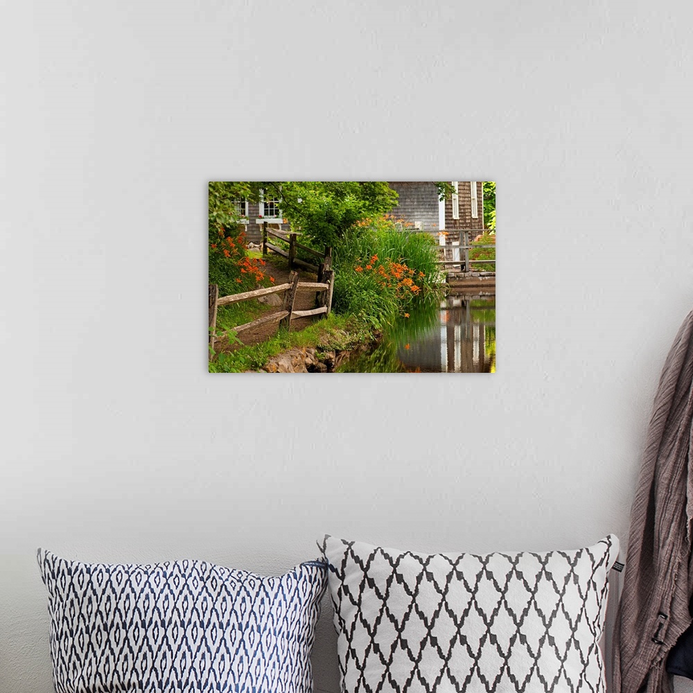 A bohemian room featuring Reflections in stream and flowers in bloom at Stony Brook Grist Mill.