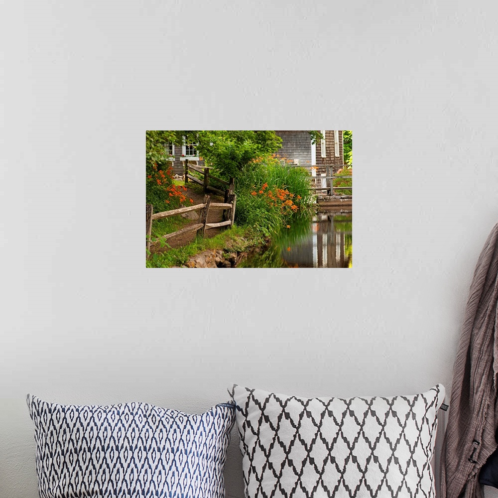 A bohemian room featuring Reflections in stream and flowers in bloom at Stony Brook Grist Mill.
