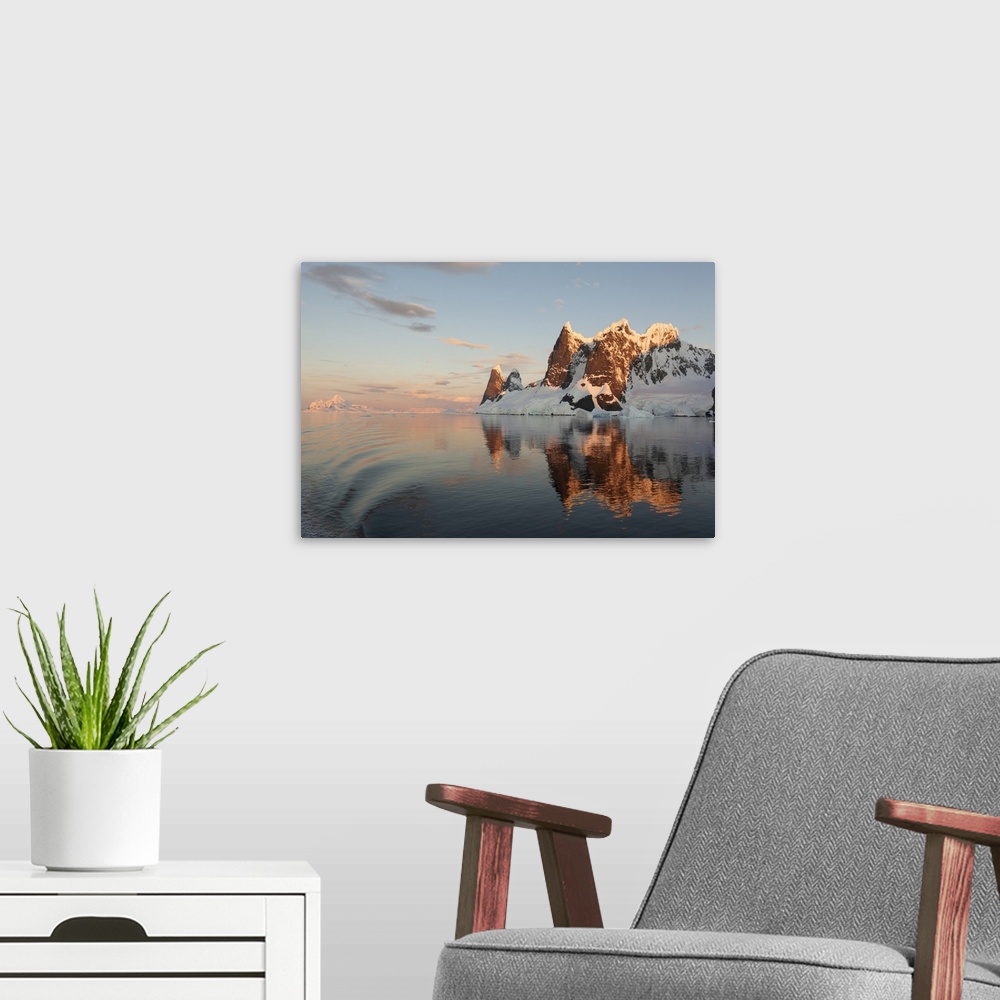 A modern room featuring Reflections of cliffs and mountains in the Lemaire Channel at sunset, Antarctica