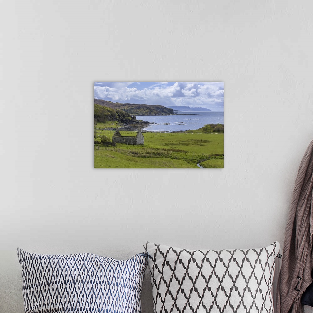 A bohemian room featuring Remains of a stone house in grassy field along the coast on the Isle of Skye in Scotland, United ...