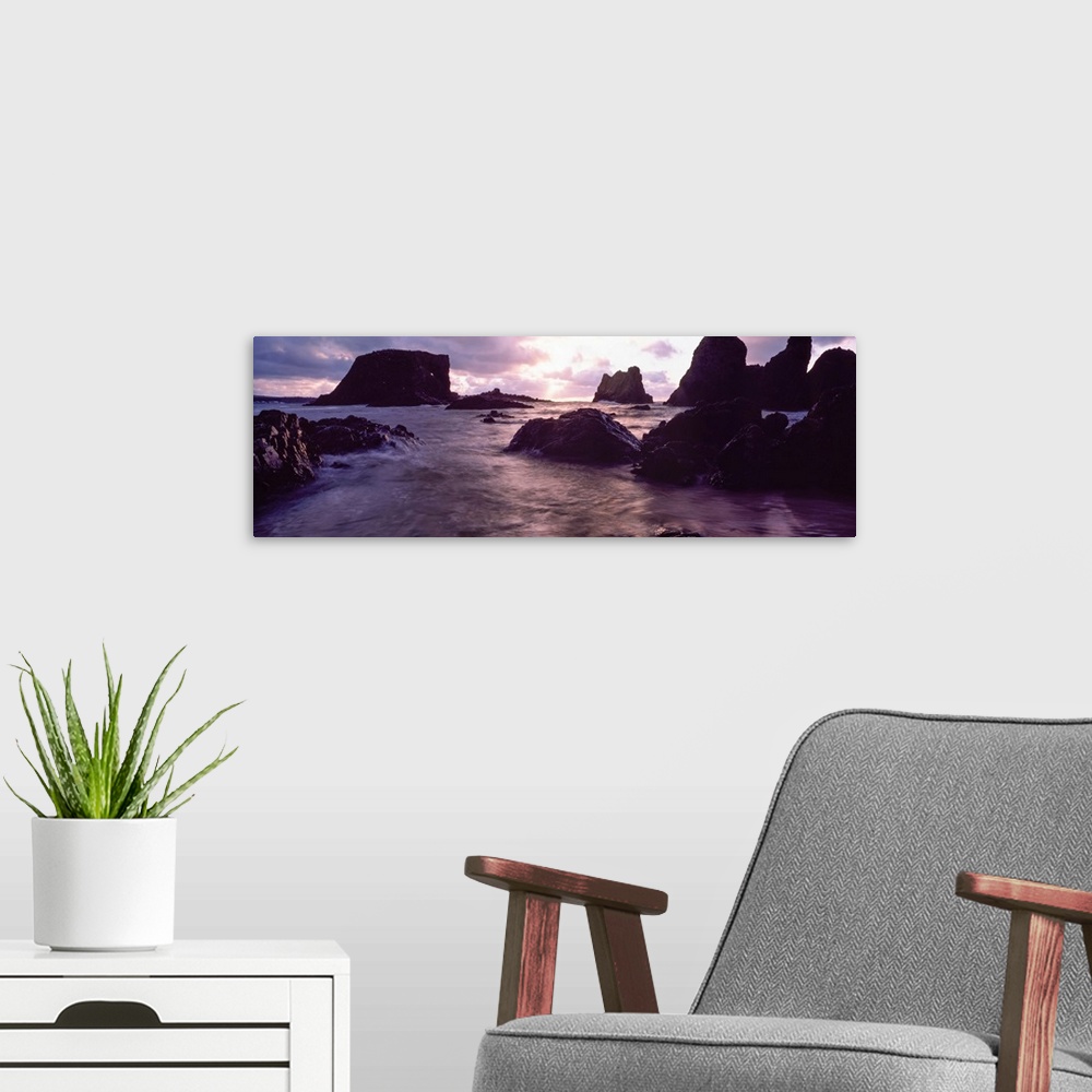 A modern room featuring Rocks in the sea at sunset, Whiterocks, Co Antrim, Ireland.