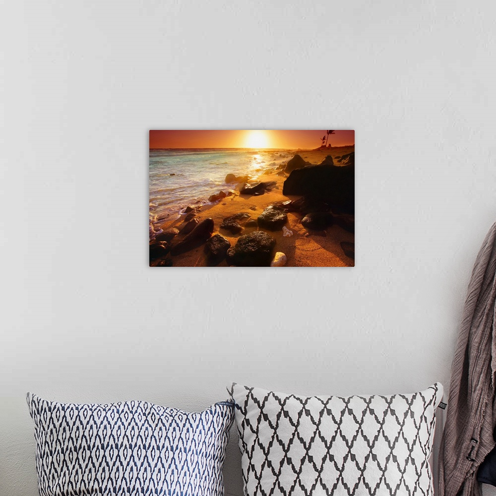 A bohemian room featuring Photograph taken of a sunset on the ocean horizon with various rocks spread out on the beach in t...