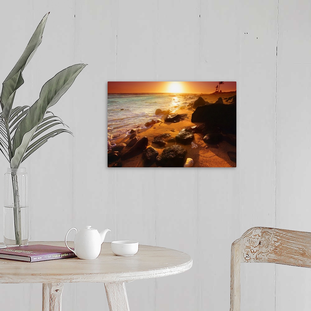 A farmhouse room featuring Photograph taken of a sunset on the ocean horizon with various rocks spread out on the beach in t...