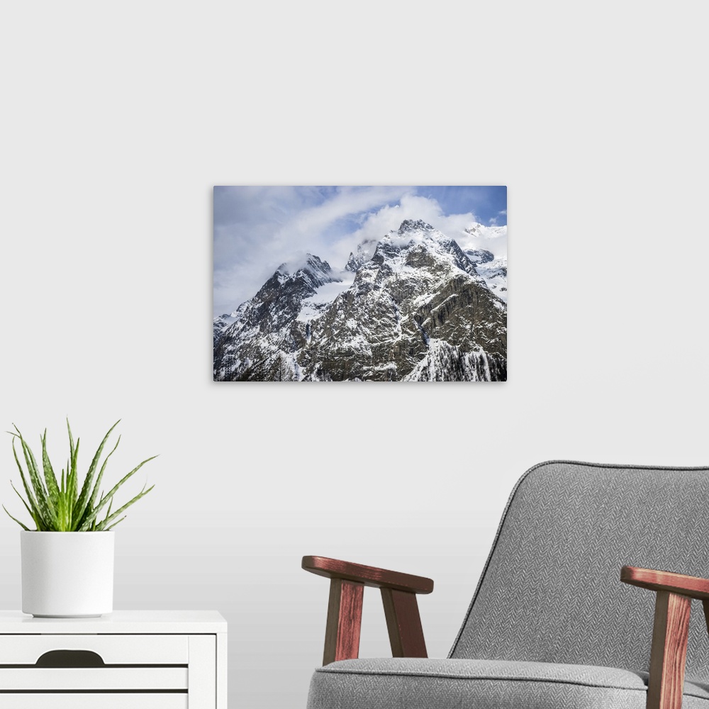 A modern room featuring Rugged peaks of snow-covered mountains, Italian side of Mont Blanc; Courmayeur, Valle D'Aosta, It...