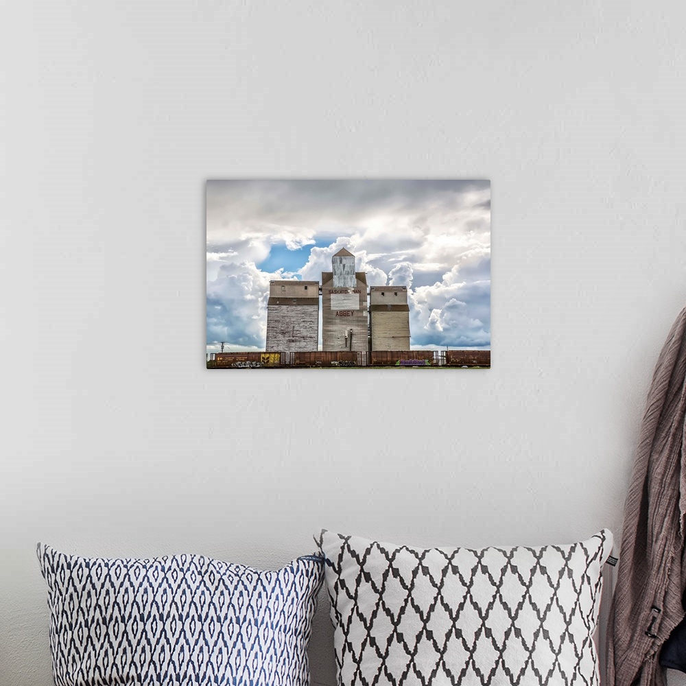 A bohemian room featuring Rural grain elevator with cumulonimbus clouds building up around it, Saskatchewan, Canada.