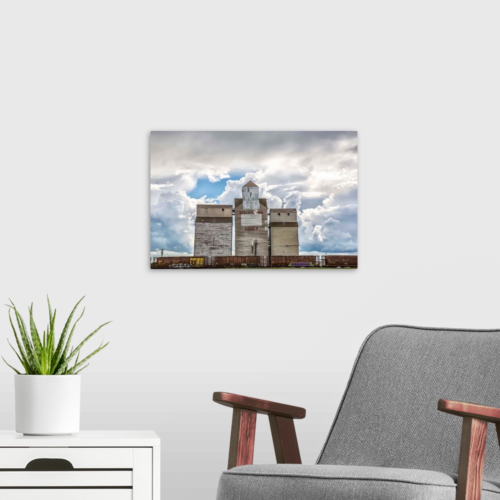 A modern room featuring Rural grain elevator with cumulonimbus clouds building up around it, Saskatchewan, Canada.