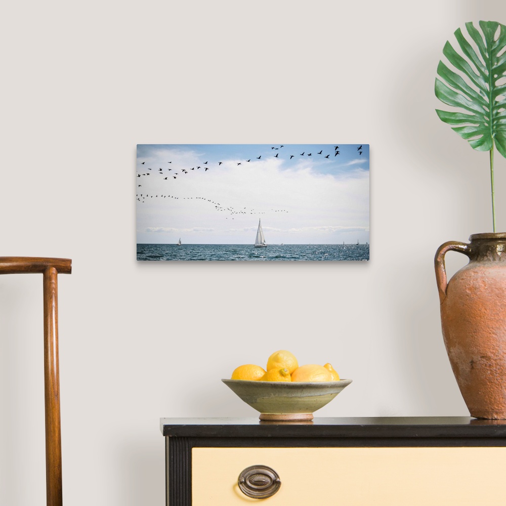 A traditional room featuring Sailboats cruise the waters of Lake Ontario as a flock of water birds take to the air, Toronto, O...
