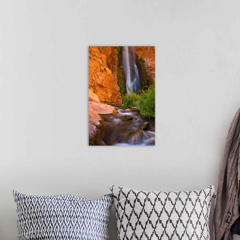 A bohemian room featuring This photograph is from the National Geographic Collection showing a waterfall cascading into a s...