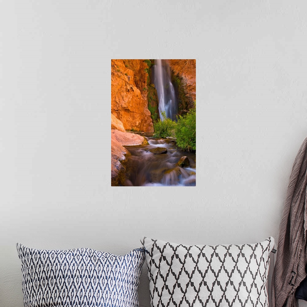 A bohemian room featuring This photograph is from the National Geographic Collection showing a waterfall cascading into a s...
