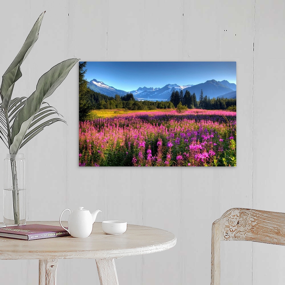 A farmhouse room featuring Oversized wall art of a meadow of wildflowers in a valley of evergreen trees with an Alaskan glac...
