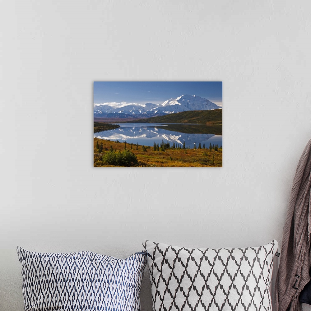 A bohemian room featuring Photograph of lake surrounded by grassy hills, trees, and bushes with snow covered mountains in t...