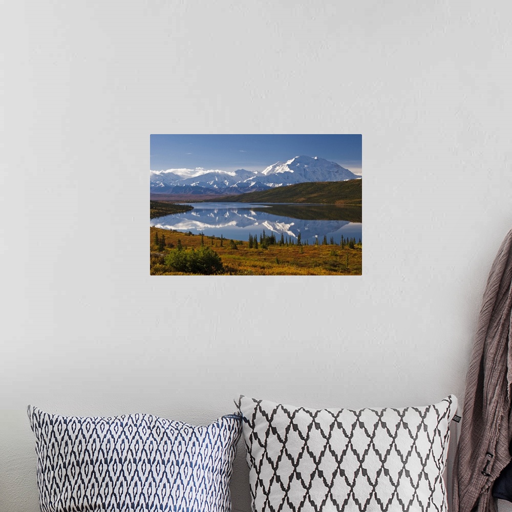 A bohemian room featuring Photograph of lake surrounded by grassy hills, trees, and bushes with snow covered mountains in t...