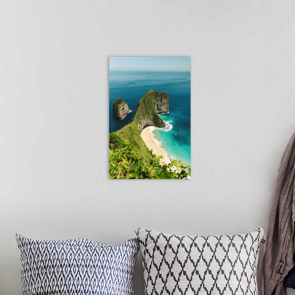 A bohemian room featuring Sea stack and rock formation along coastline jutting out into the ocean in the Nusa Islands, Klun...