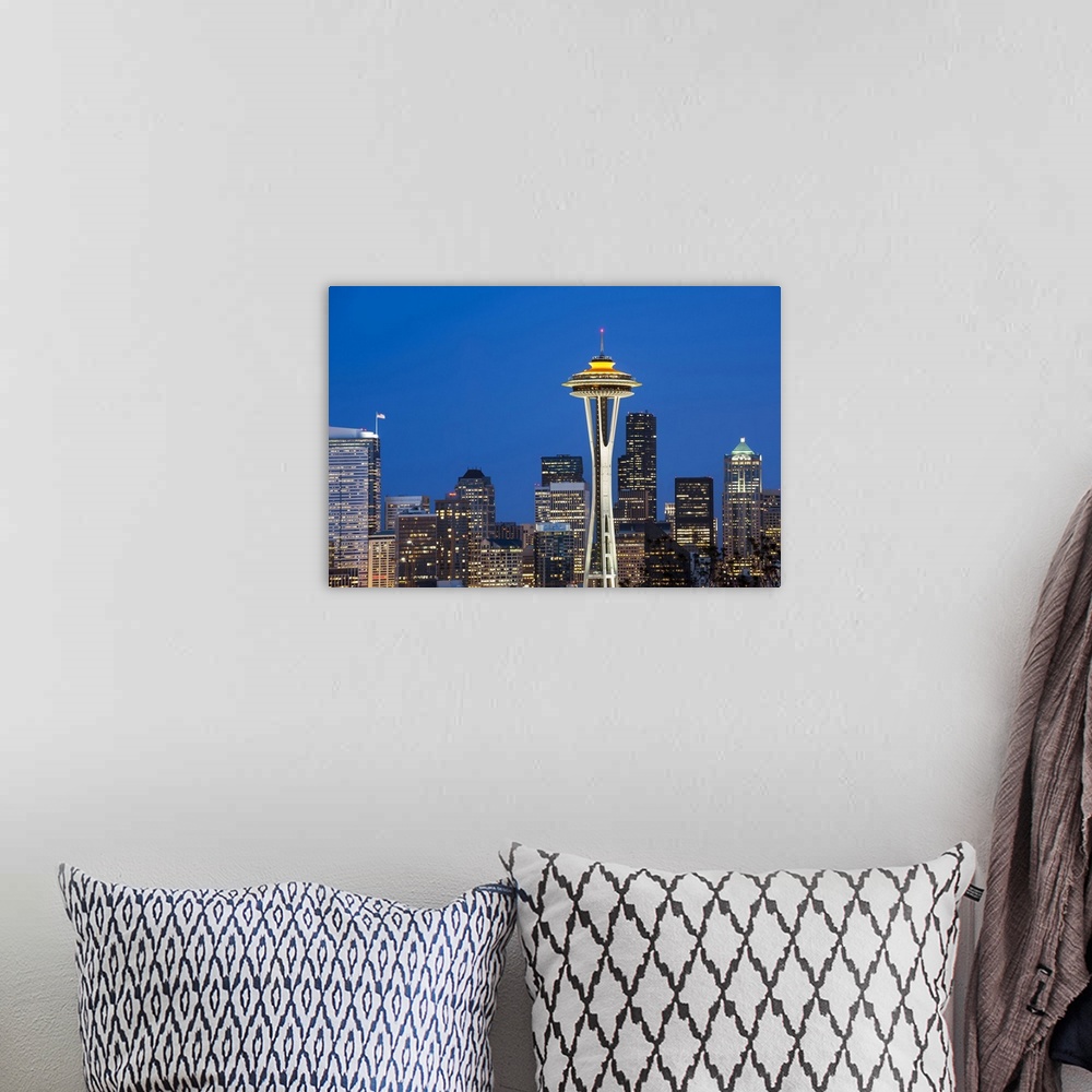 A bohemian room featuring Seattle and the Space Needle by night.