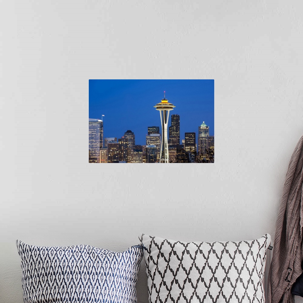 A bohemian room featuring Seattle and the Space Needle by night.