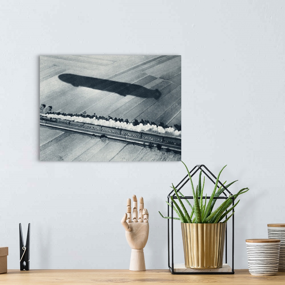 A bohemian room featuring Shadow Of The Fast Zeppelin Air Ship Schwaben Keeping Pace With An Express Train. From The Illust...