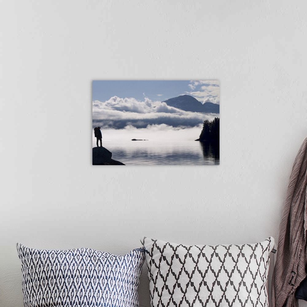 A bohemian room featuring Silhouette of a backpacker along Lynn Canal near Juneau with Chilkat Mountains, Alaska