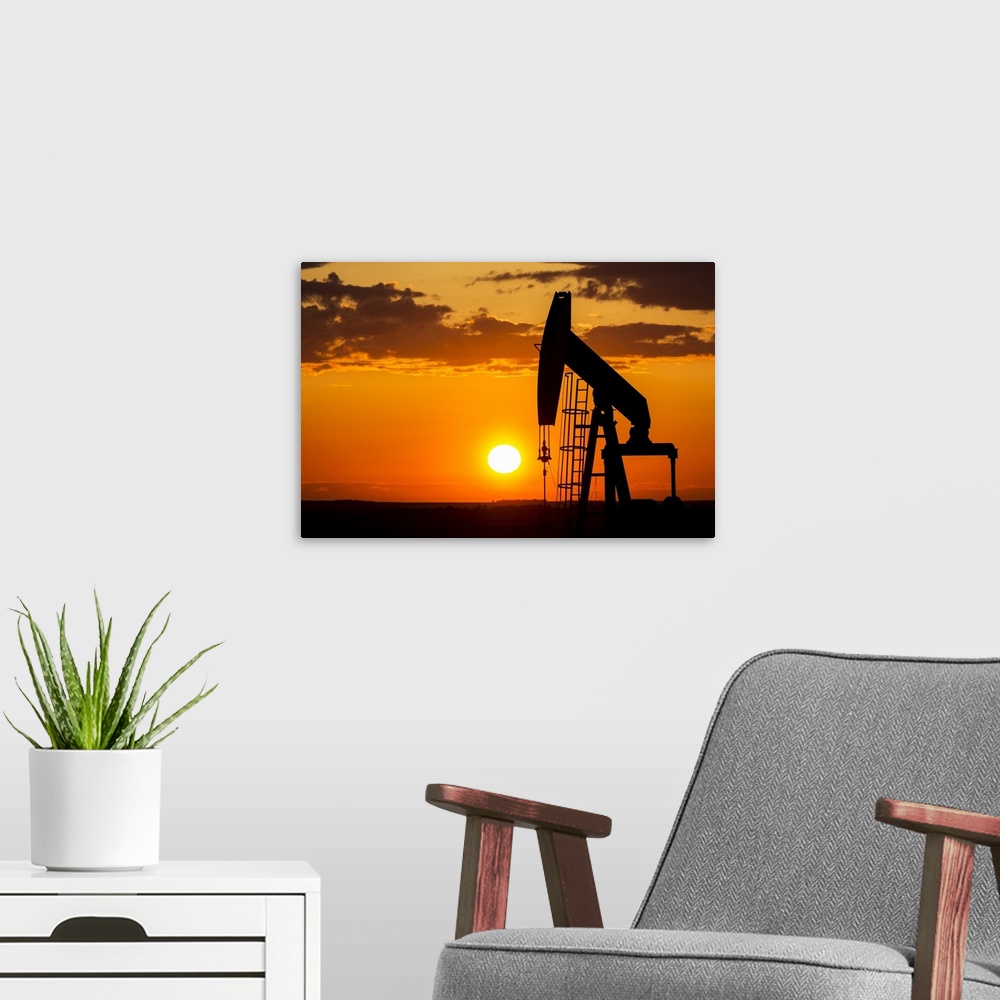 A modern room featuring Silhouette Of A Pump Jack At Sunrise With A Colorful Orange Sun, Clouds And Sky; Alberta, Canada