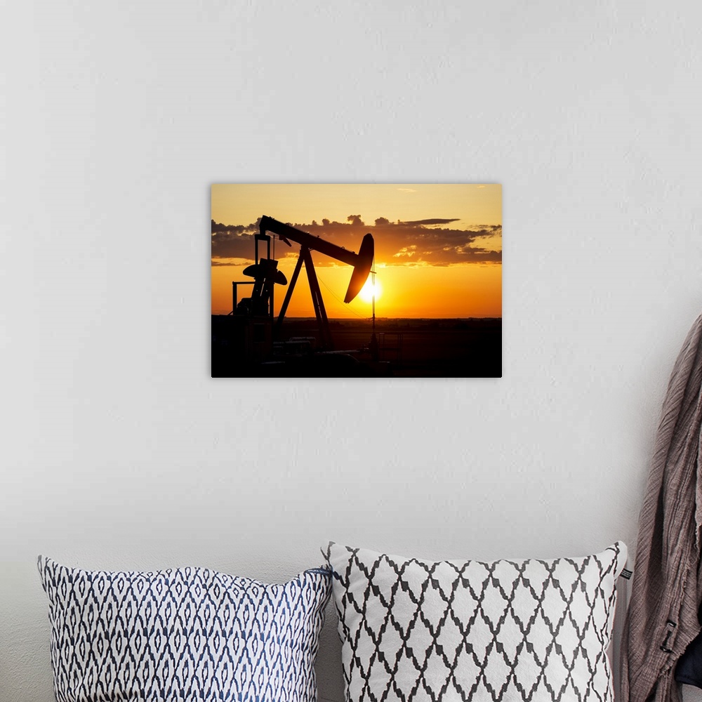 A bohemian room featuring Silhouette Of A Pump Jack At Sunrise With A Colorful Orange Sun, Clouds And Sky; Alberta, Canada
