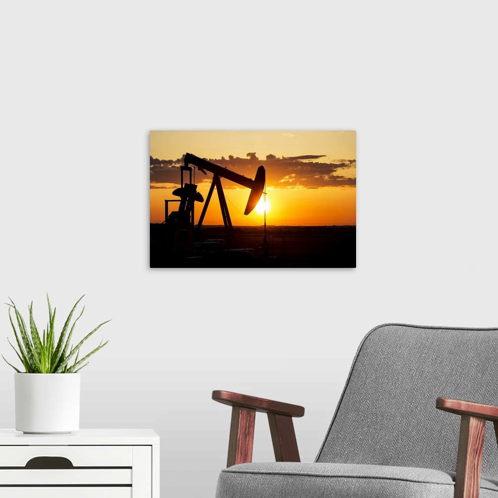 A modern room featuring Silhouette Of A Pump Jack At Sunrise With A Colorful Orange Sun, Clouds And Sky; Alberta, Canada
