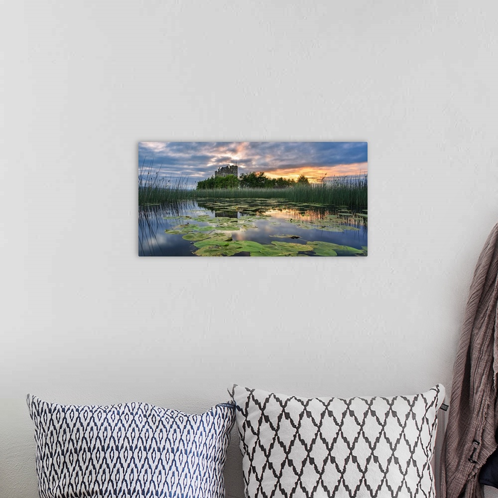 A bohemian room featuring Small castle on an island on Lough Derg at sunrise in summer with lily pads floating on the lake ...