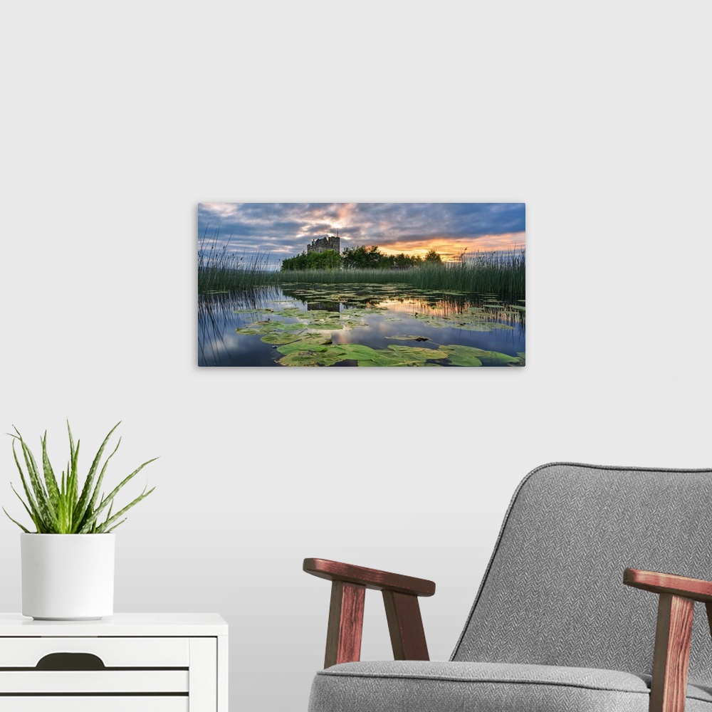 A modern room featuring Small castle on an island on Lough Derg at sunrise in summer with lily pads floating on the lake ...