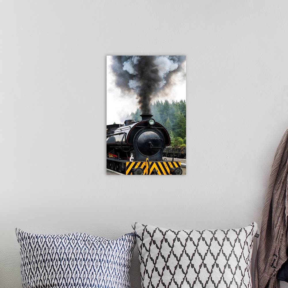A bohemian room featuring Smoke billows from the engine of a train; North Yorkshire, England