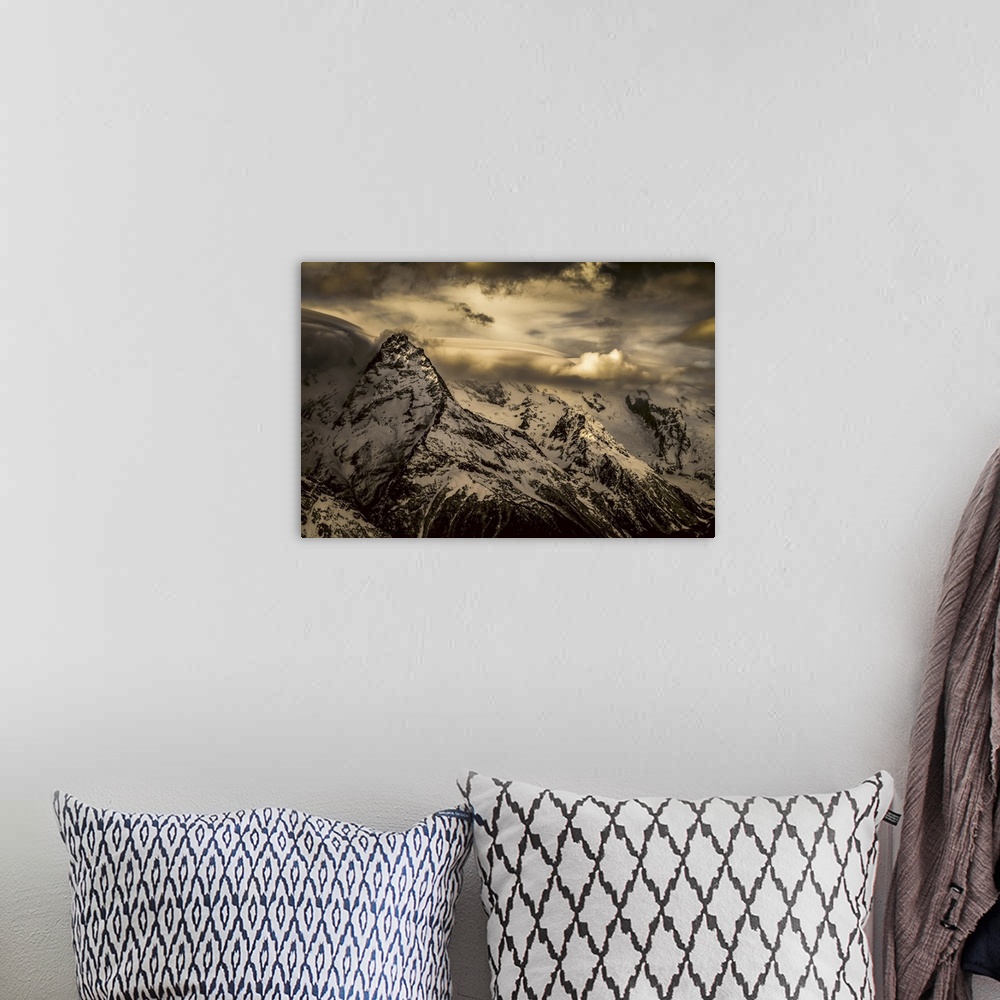 A bohemian room featuring Dramatic view of snow-covered Caucasus mountains and glowing clouds, dombay region, Karachaevo-Ch...