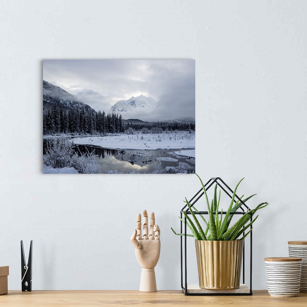 A bohemian room featuring Snow covers the mountainous and forested landscape in Chugach state park, eagle river, Alaska, un...