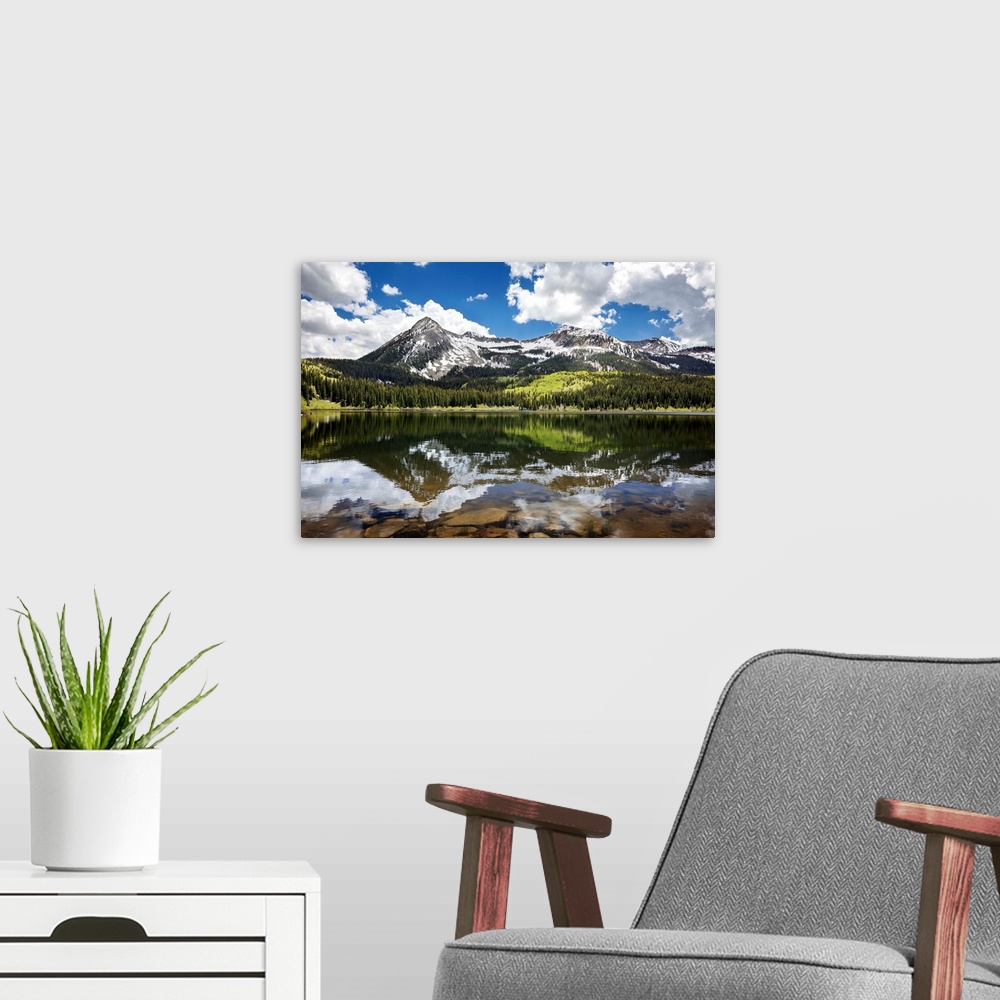 A modern room featuring Snowcapped East Beckwith mountain in the background reflected in Lost Lake Slough; Colorado, Unit...