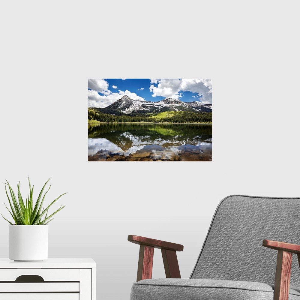 A modern room featuring Snowcapped East Beckwith mountain in the background reflected in Lost Lake Slough; Colorado, Unit...