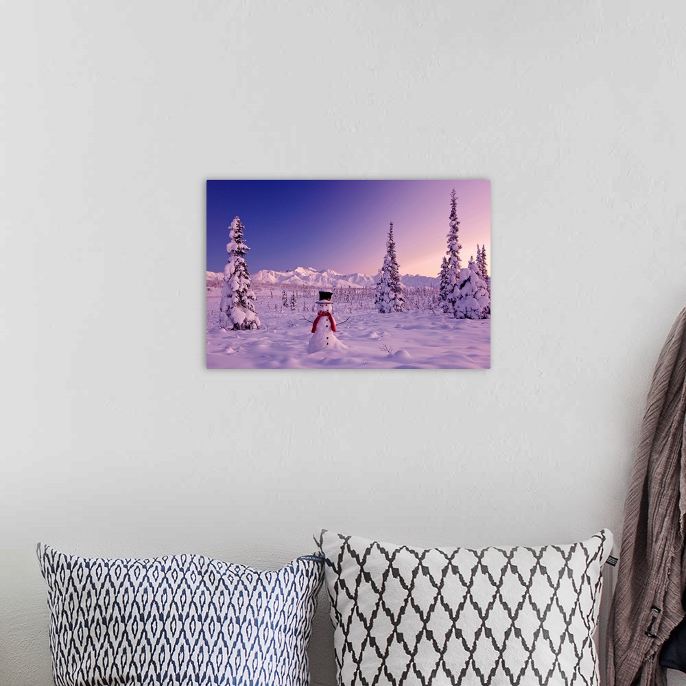 A bohemian room featuring Large canvas photo of a snowman sitting in a snowy landscape with mountains in the distance and s...